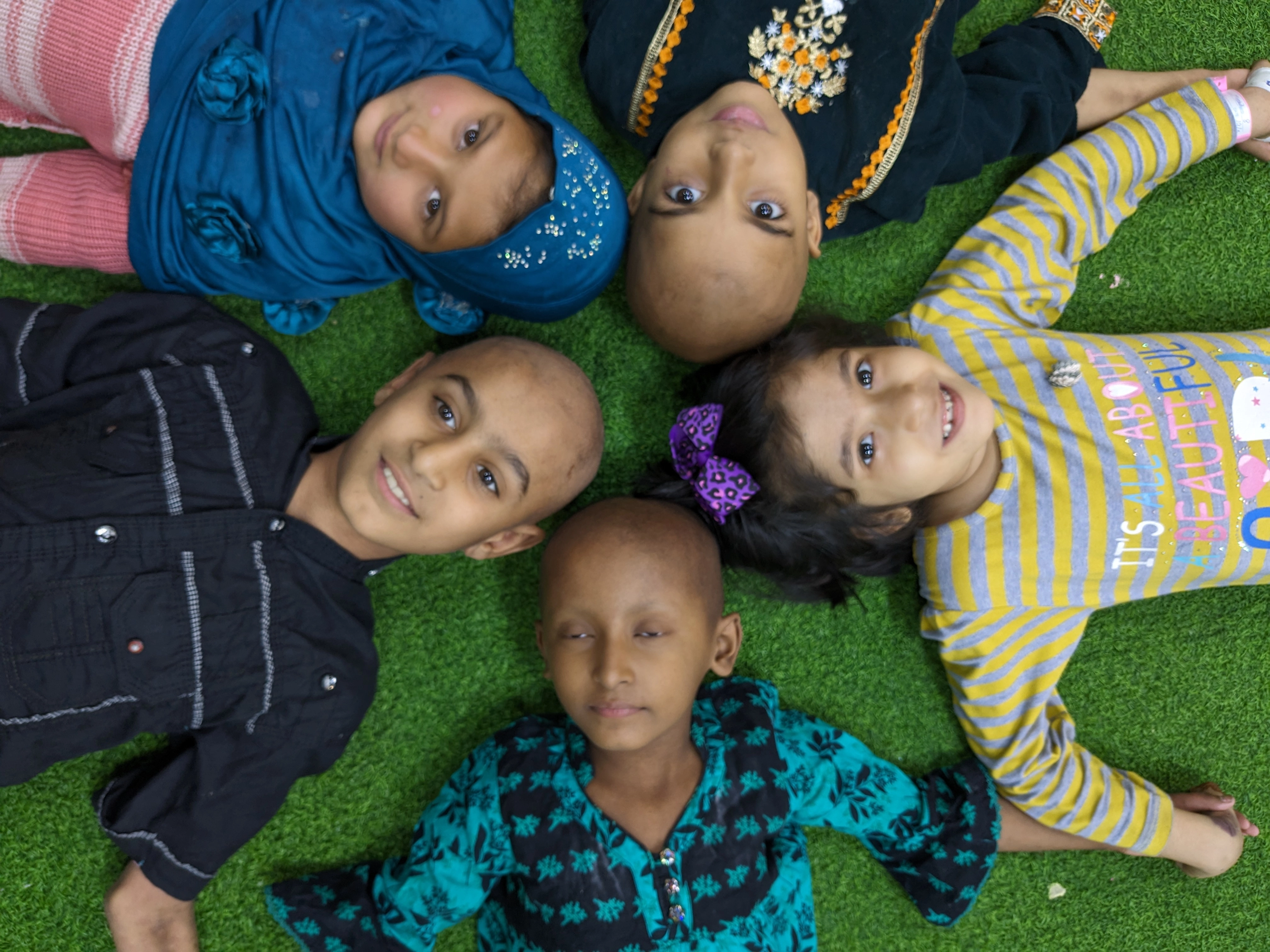 Children smiling and playing, CCCF Pakistan homepage hero image